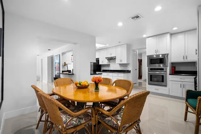 a dining room with furniture and wooden floor