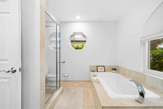 a bathroom with a tub and shower