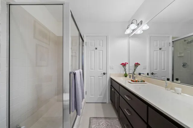 a bathroom with a double vanity sink and mirror