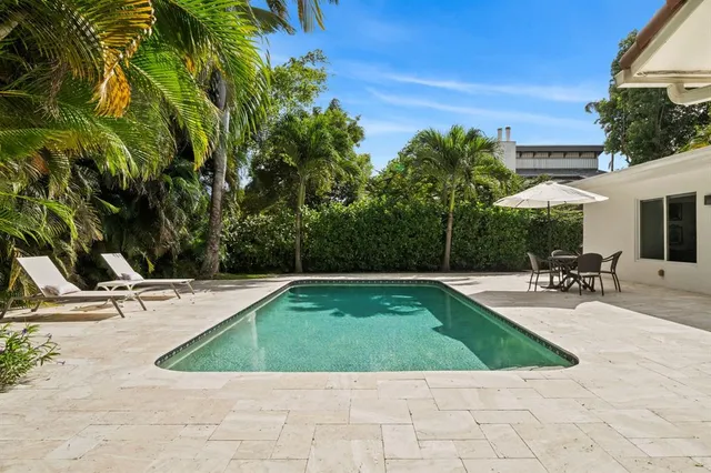 a view of a swimming pool with chairs