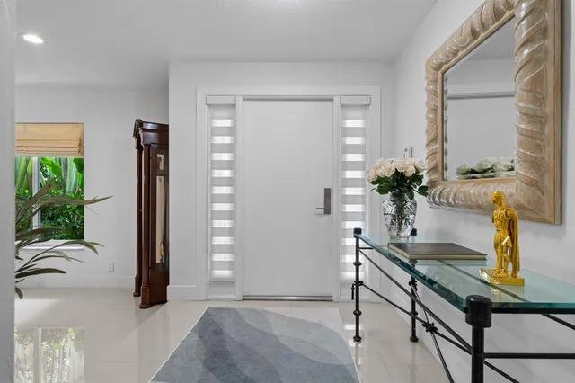 a living room with furniture and potted plant