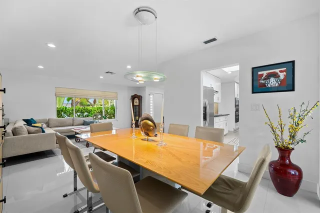 a room with table chairs and a chandelier