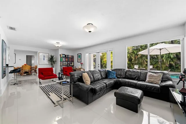 a living room with furniture and a large window