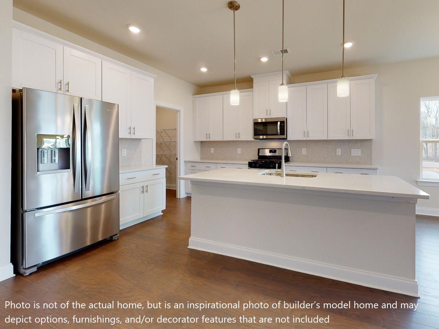 1104 Holland Ridge Way Lebanon, TN 37090 - Photo 25 of 26 a kitchen with kitchen island a refrigerator a stove a sink and a oven