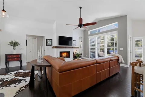 a living room with furniture a chandelier and a window