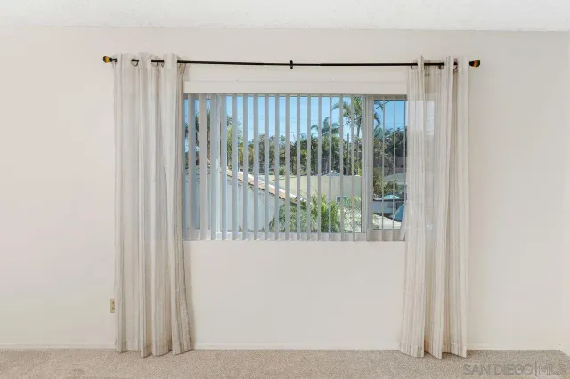 a bathroom with a granite countertop toilet a mirror and a shower