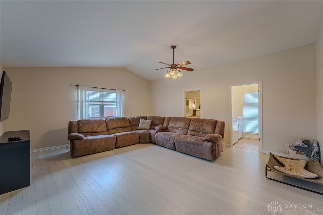 305 South Vandemark Road Sidney, OH 45365 - Photo 21 of 32 This bright living room features high ceilings, a ceiling fan, and light-toned flooring.