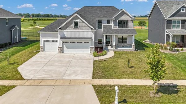 a view of house with garden space and swimming pool