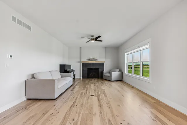 a living room with furniture and kitchen view