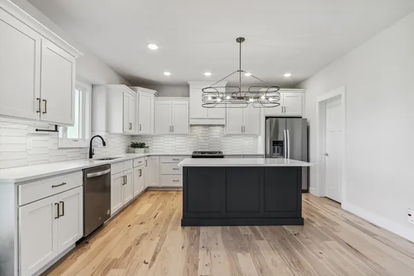 a stove top oven sitting inside of a kitchen
