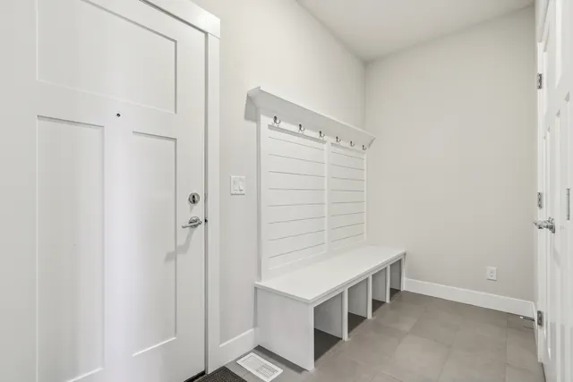 a spacious bathroom with a double vanity sink a mirror and a bathtub