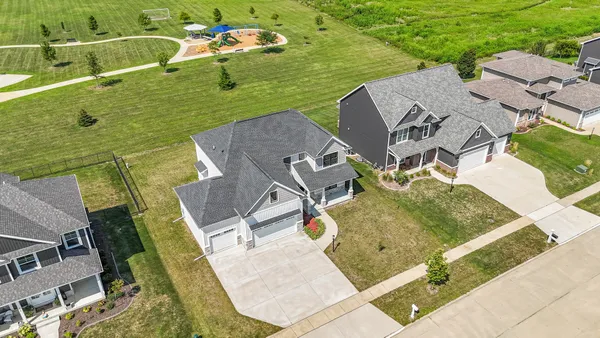 an aerial view of a house with a yard