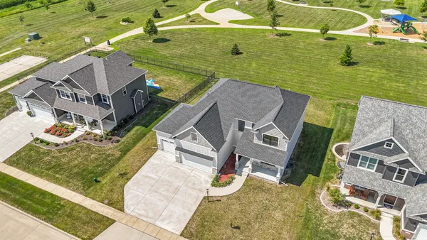 a front view of a house with swimming pool and porch