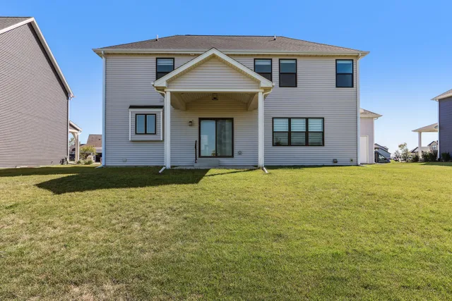 a view of a swimming pool and lounge chairs in the garden