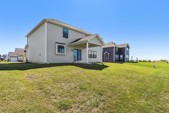 an aerial view of a residential houses with outdoor space and mountain view