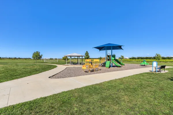a picture of a bench in front of a gate
