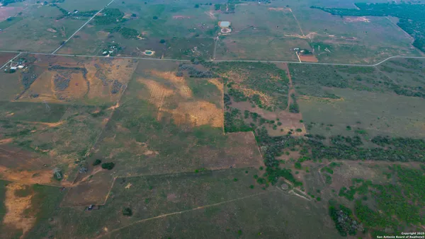 an aerial view of a house with a yard