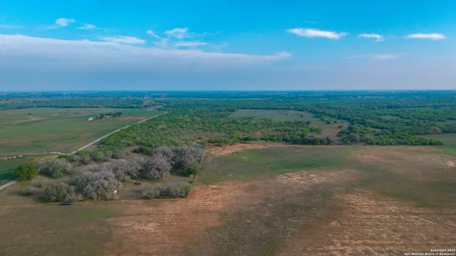 a view of a field with an ocean