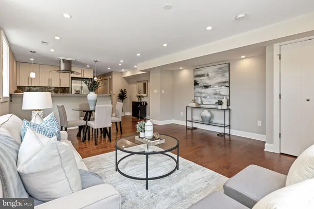 a living room with furniture and kitchen view