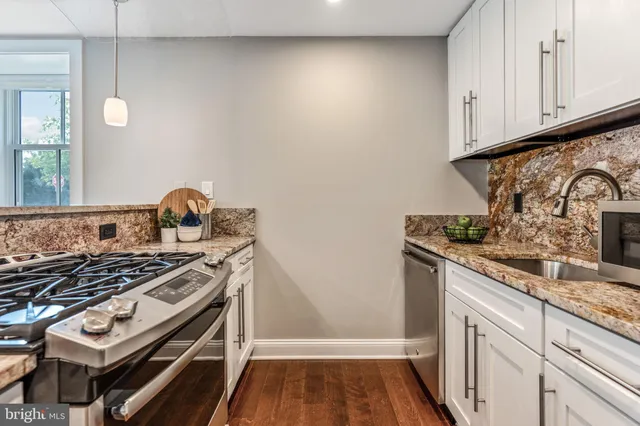a kitchen with a stove and a sink