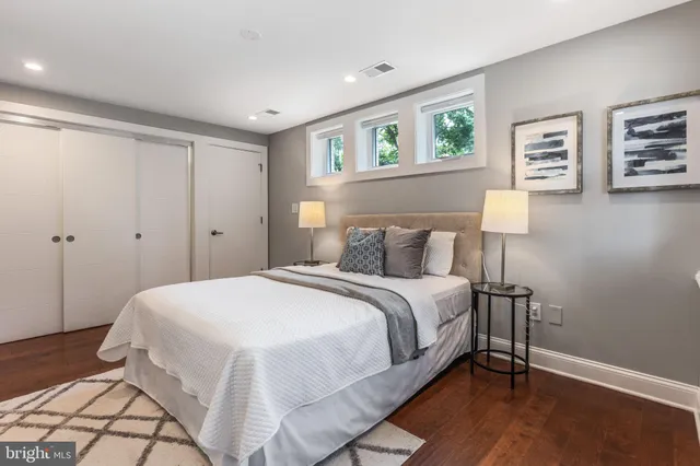 a bedroom with a bed and a night stand