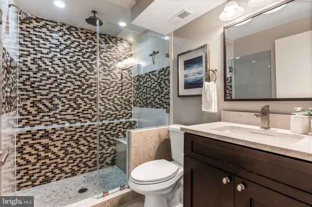 a bathroom with a toilet and a shower