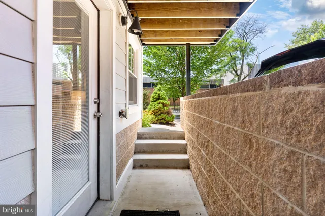 a view of a porch with wooden floor and windows