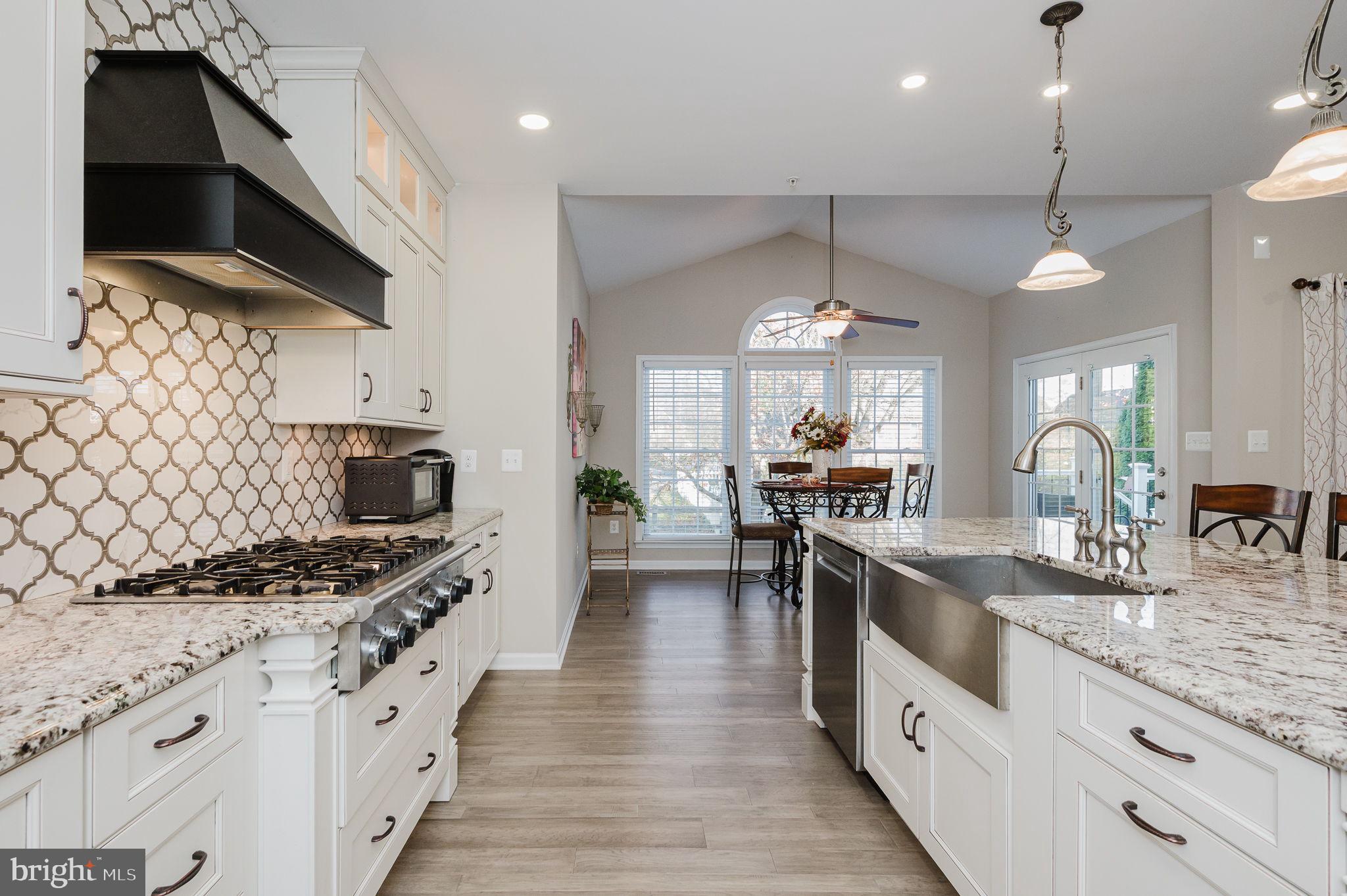 823 Bridle Path Bel Air, MD 21014 - Photo 19 of 66 a kitchen with granite countertop a sink stove and cabinets
