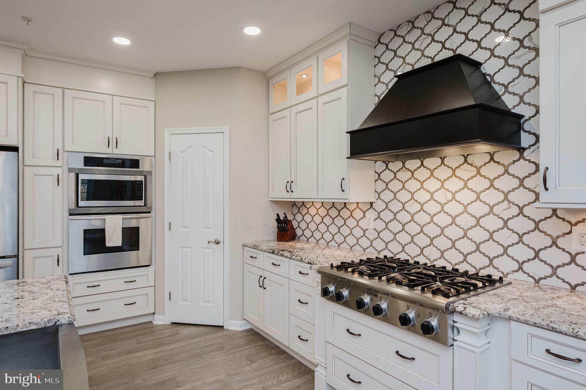 823 Bridle Path Bel Air, MD 21014 - Photo 22 of 66 a kitchen with stainless steel appliances a stove a microwave and cabinets