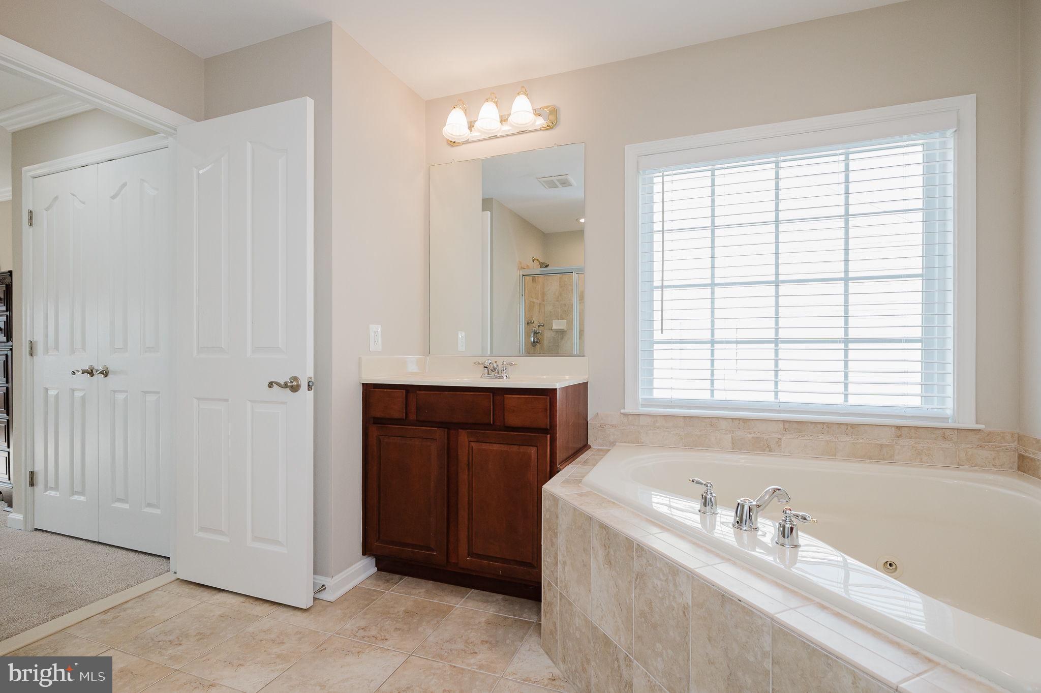 823 Bridle Path Bel Air, MD 21014 - Photo 37 of 66 a bathroom with a tub a sink and a window