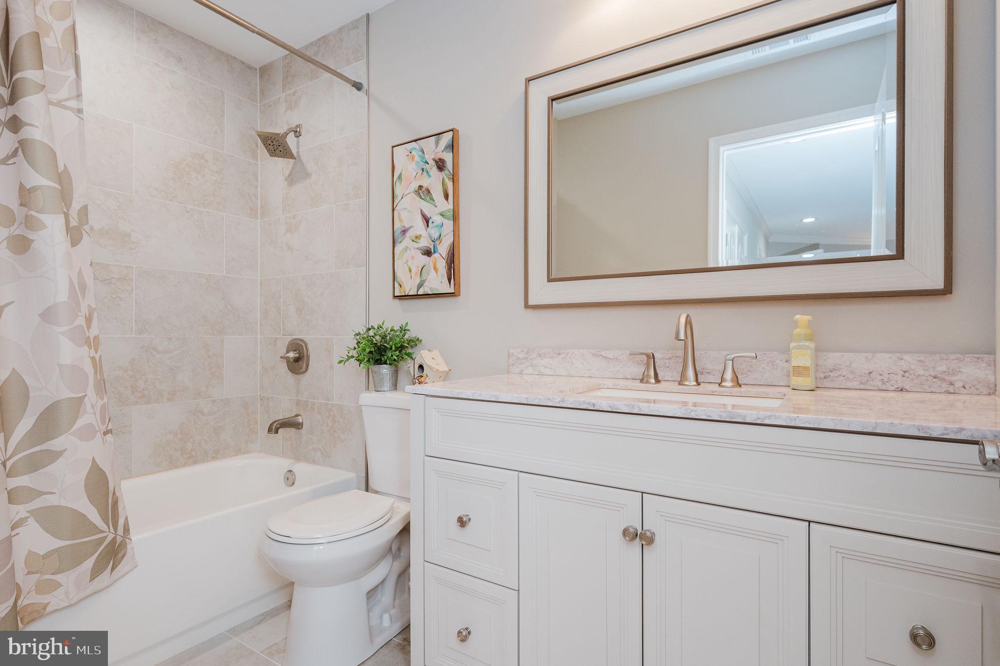 823 Bridle Path Bel Air, MD 21014 - Photo 41 of 66 a bathroom with a granite countertop toilet a sink and a bathtub