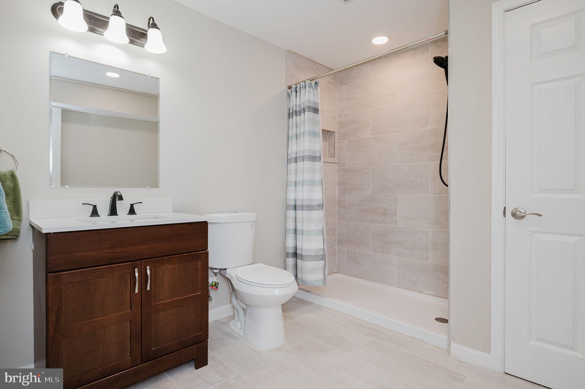 823 Bridle Path Bel Air, MD 21014 - Photo 49 of 66 a bathroom with a shower sink vanity mirror and toilet