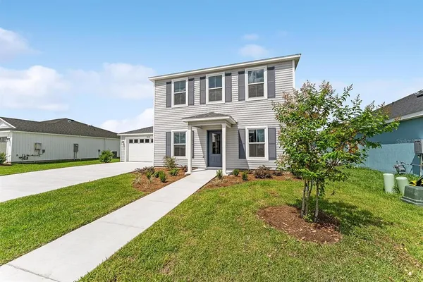 a front view of house with yard and green space