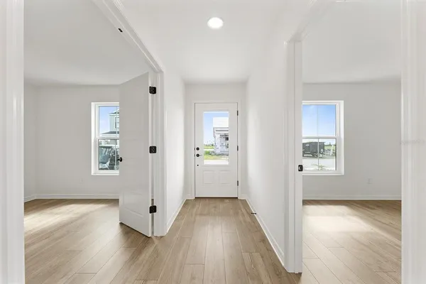 a view of an empty room with wooden floor