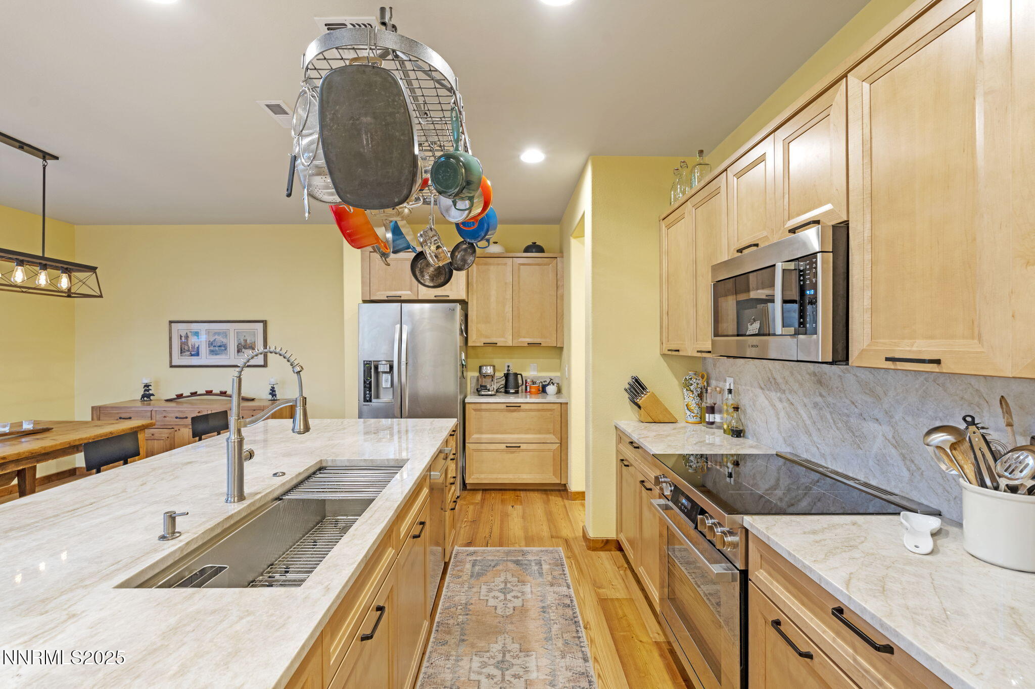 2117 Tara Ridge Trail Reno, NV 89523 - Photo 13 of 25 a large kitchen with stainless steel appliances granite countertop a sink and dishwasher a stove with wooden floor