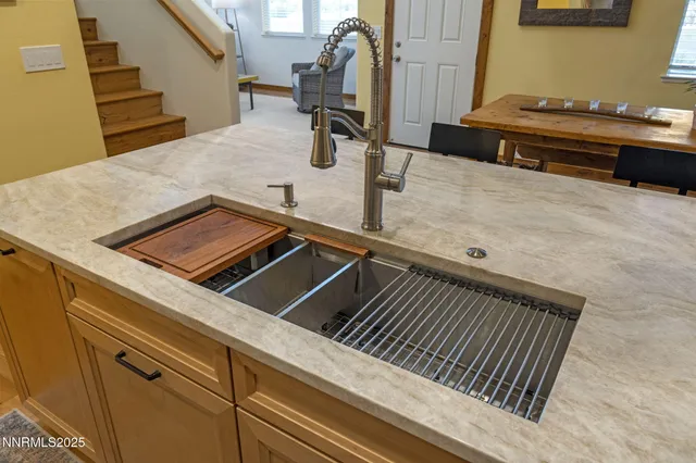 a backyard of a house with table and chairs