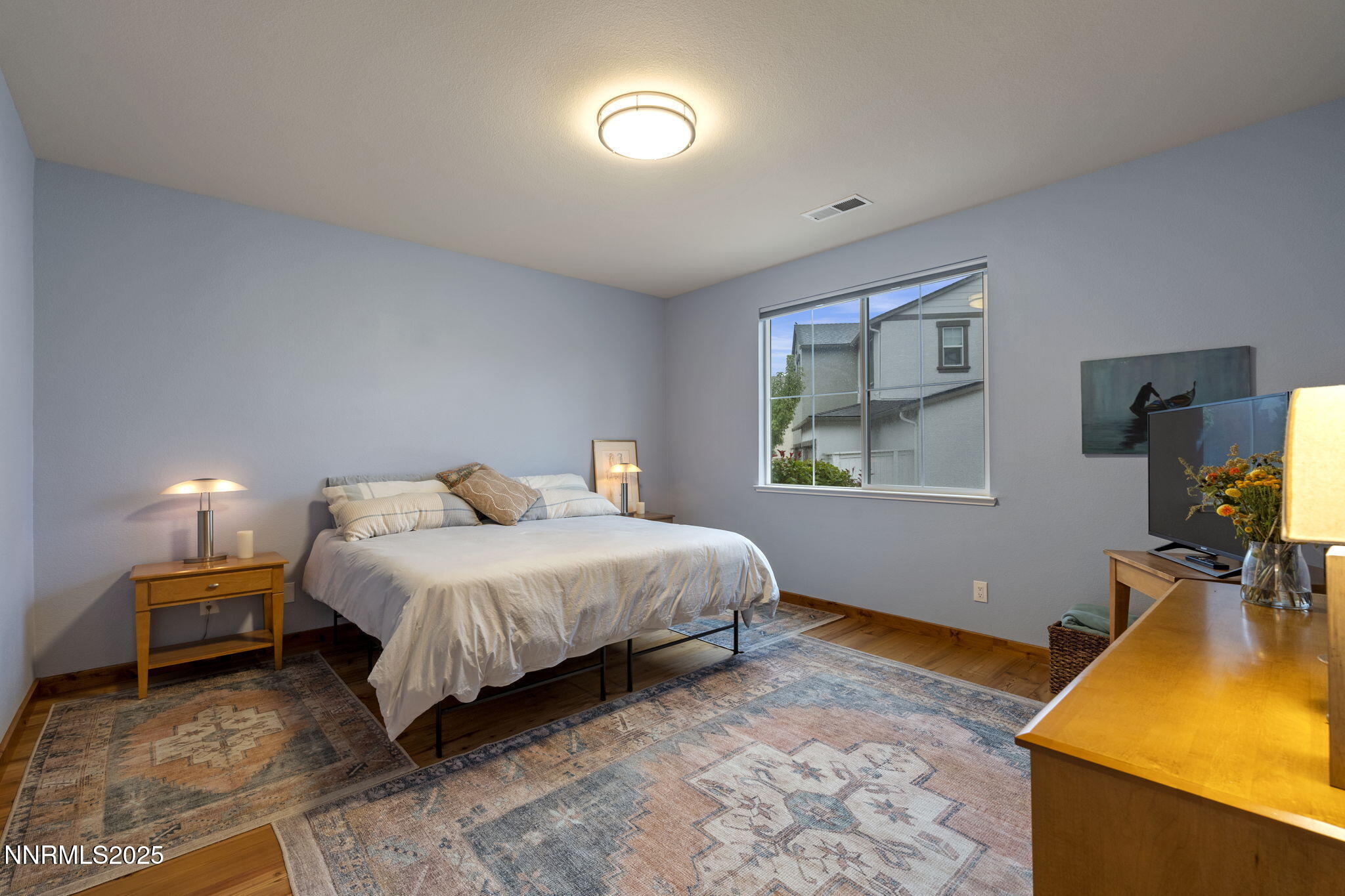2117 Tara Ridge Trail Reno, NV 89523 - Photo 16 of 25 a bedroom with a bed and a flat screen tv