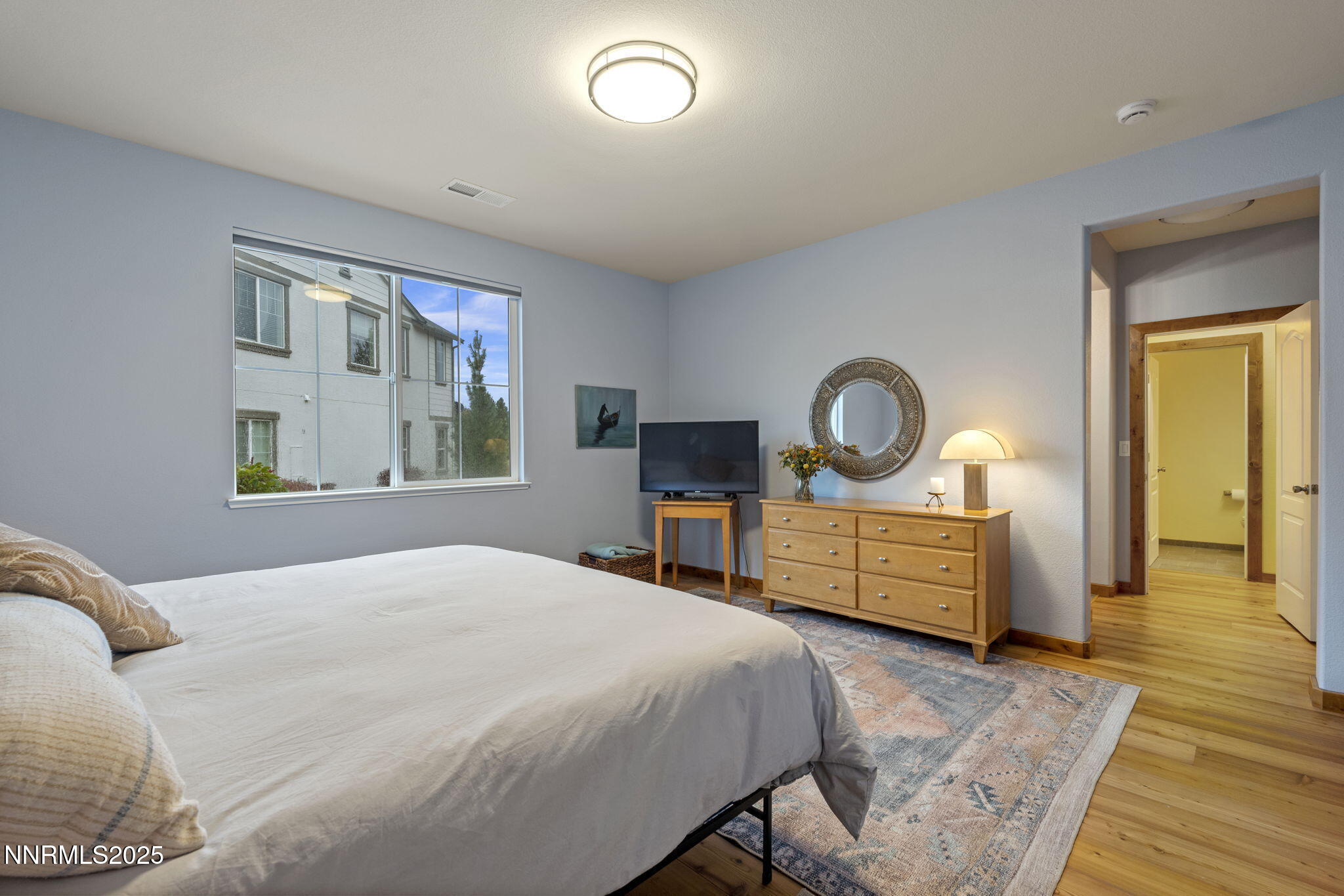 2117 Tara Ridge Trail Reno, NV 89523 - Photo 17 of 25 a bedroom with a bed table closet and a window