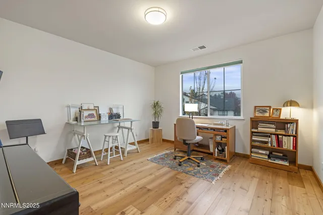 a view of a workspace with furniture and a workspace