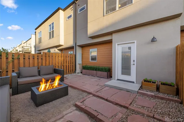 a view of a house with backyard and wooden fence