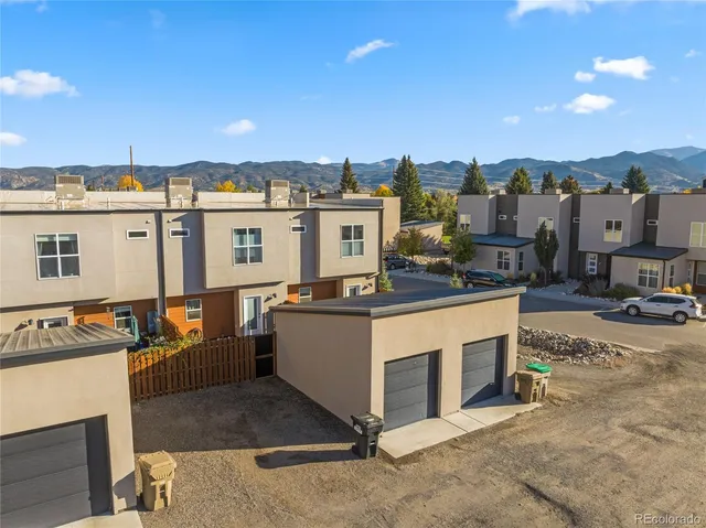 an empty room with closet and a chandelier fan