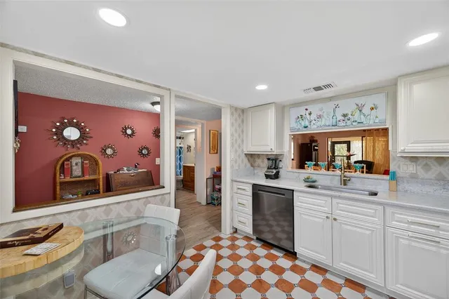 a kitchen with stainless steel appliances a sink and cabinets