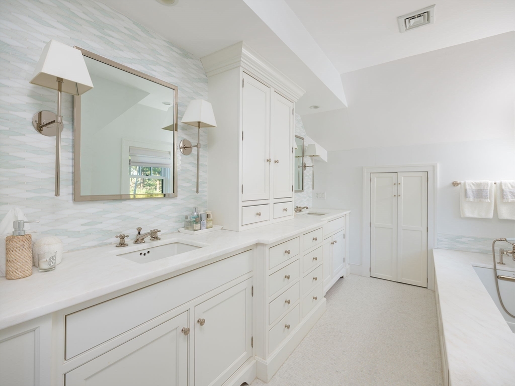 695 Summer Street Marshfield, MA 02050 - Photo 17 of 35 a bathroom with a sink double vanity and a mirror
