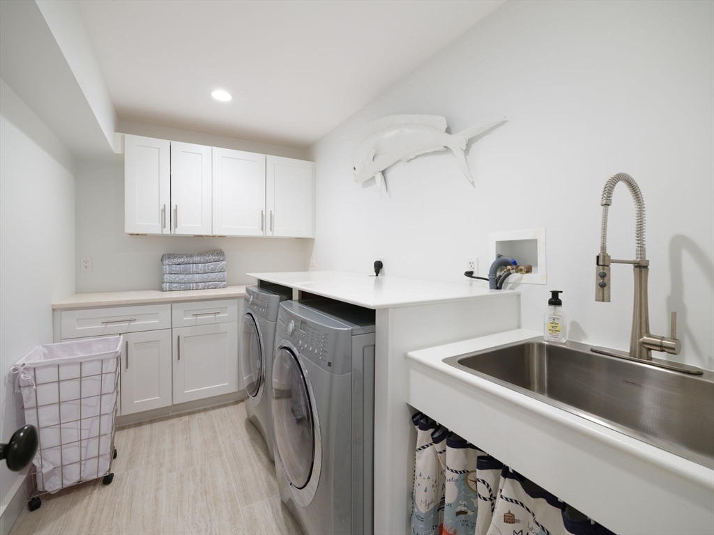 695 Summer Street Marshfield, MA 02050 - Photo 26 of 35 a kitchen with sink a washer and dryer