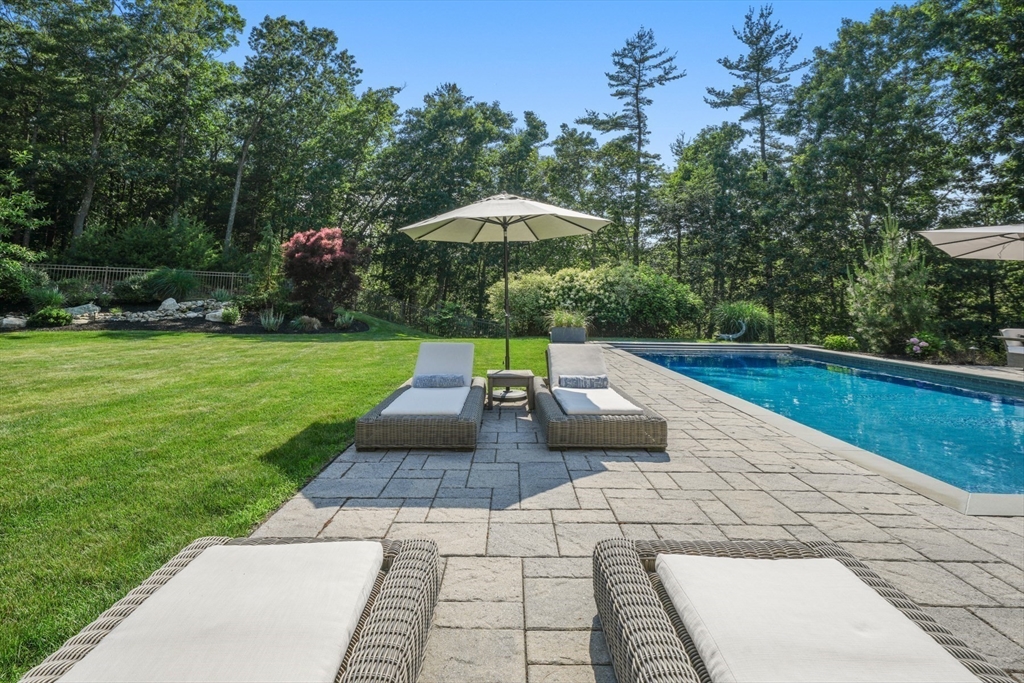 695 Summer Street Marshfield, MA 02050 - Photo 29 of 35 a view of a backyard with plants and a garden
