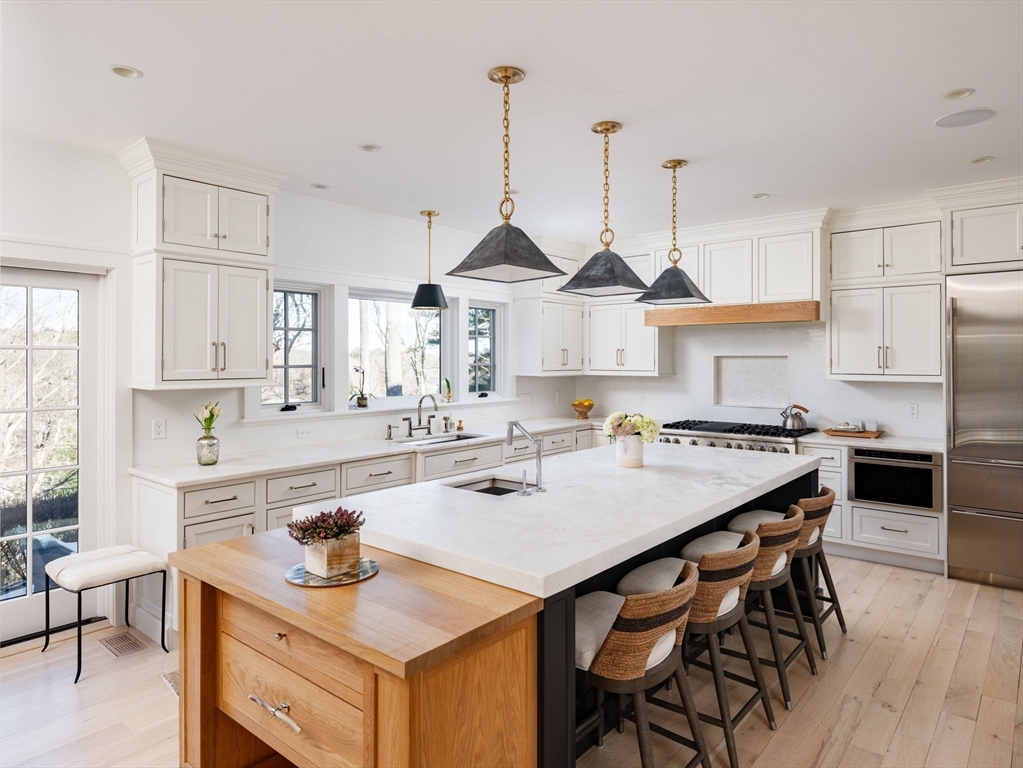 695 Summer Street Marshfield, MA 02050 - Photo 6 of 35 a kitchen with stainless steel appliances granite countertop a sink a stove and a wooden floors