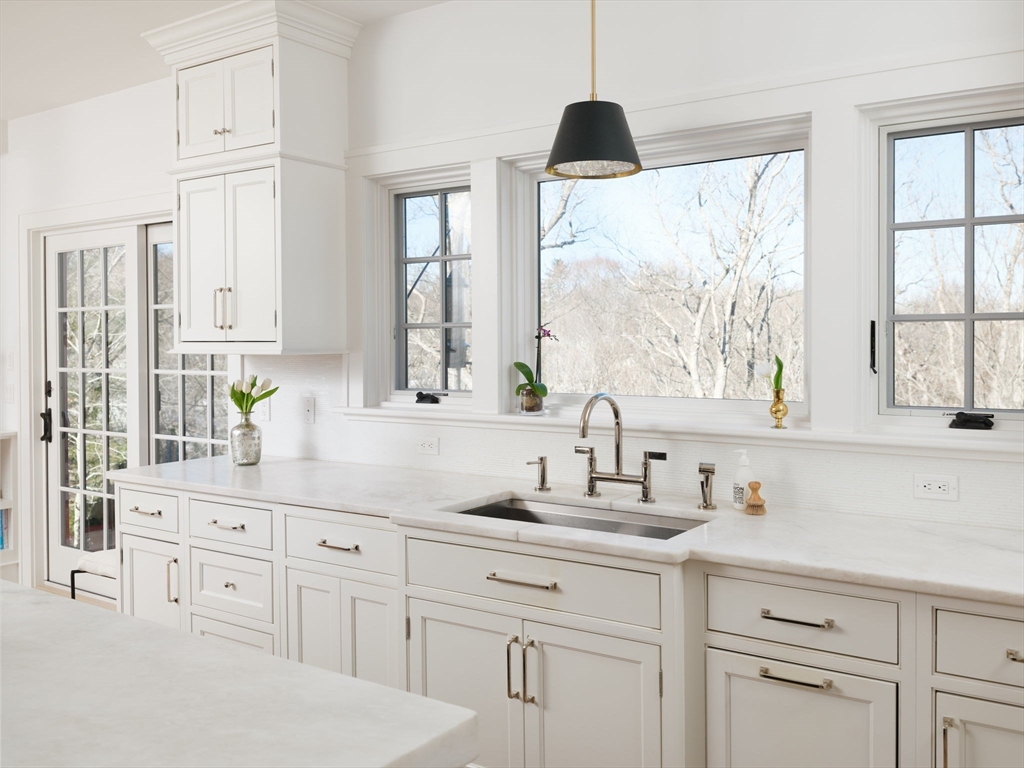 695 Summer Street Marshfield, MA 02050 - Photo 7 of 35 a kitchen with white cabinets and a large window