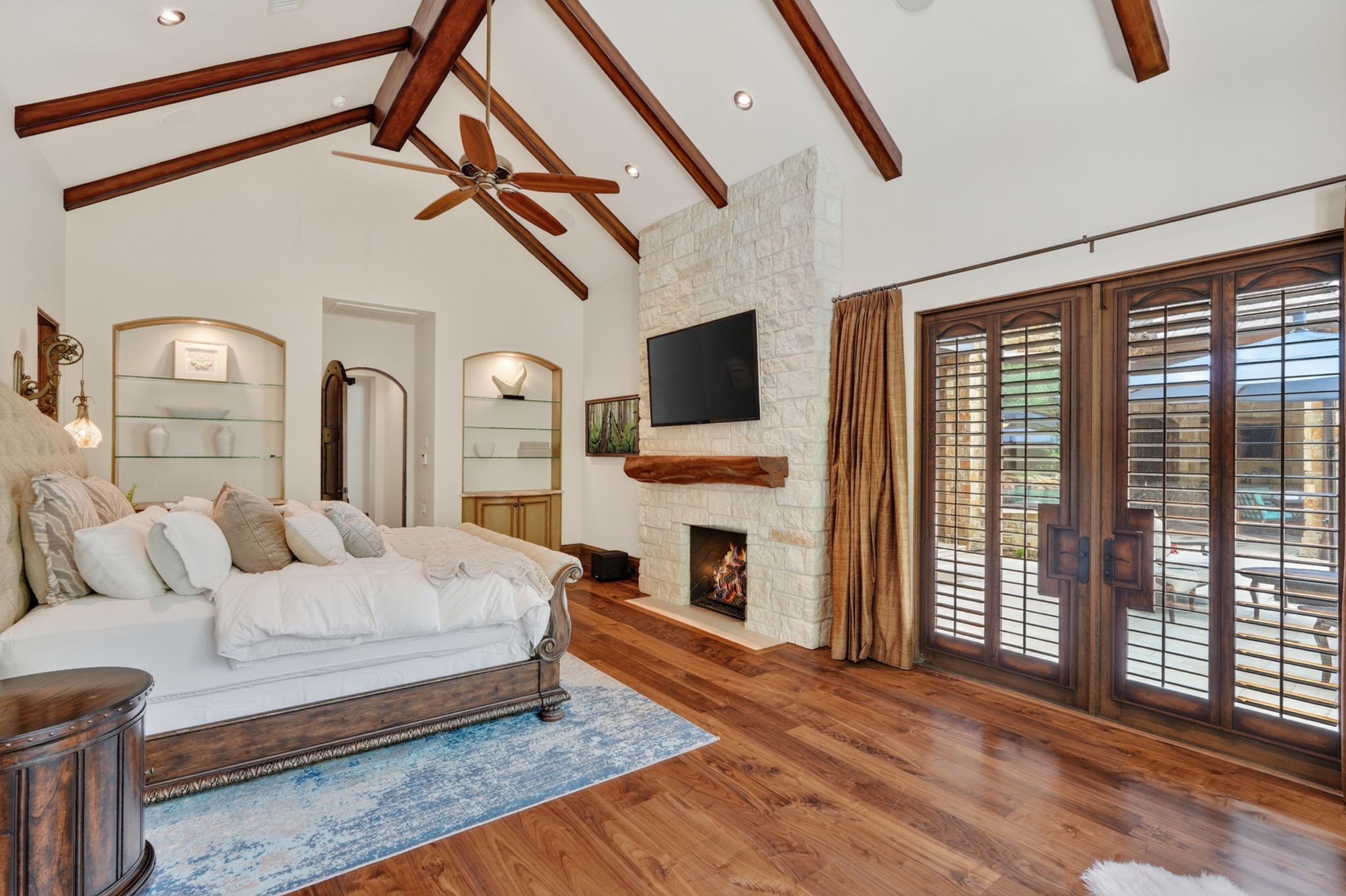 247 South Fazio Way Spring, TX 77389 - Photo 27 of 50 a bedroom with a bed a flat screen tv and a fireplace