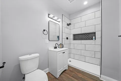 a bathroom with a toilet sink and shower
