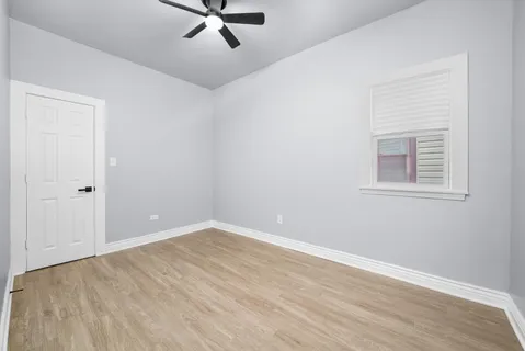 a view of a room with a wooden floor and white walls